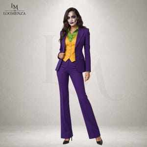 May include: A three-piece suit consisting of a purple blazer, matching purple trousers, a mustard yellow button-up vest, and a lime green collared shirt. The ensemble features a tailored fit with a single-breasted jacket and straight-leg pants.