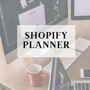 May include: A workspace with computer monitors, a laptop, and a keyboard. A red coffee mug with the Nescafe logo sits on the wooden desk. The text "SHOPIFY PLANNER" is overlaid on the image.
