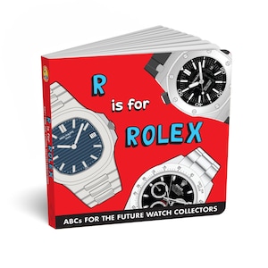 May include: A children's book with a red cover featuring the text "R is for ROLEX" and illustrations of luxury watches. The book's title is "ABCs for the Future Watch Collectors". The cover displays three different watch designs.