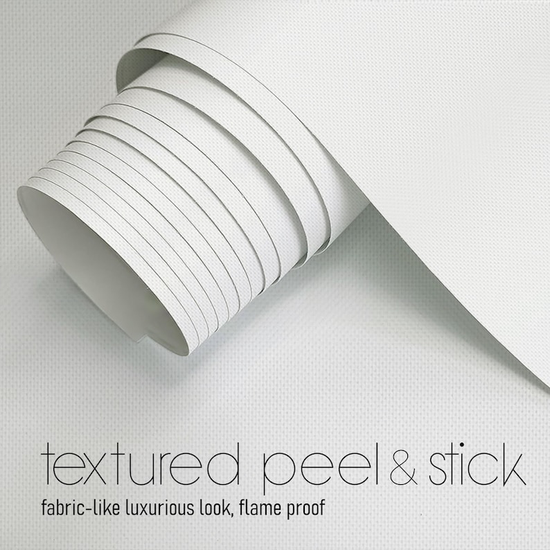 May include: A roll of white, textured peel and stick material. The material is rolled up, revealing the interior and the edge of the roll. The text "textured peel & stick" and "fabric-like luxurious look, flame proof" are visible.