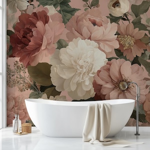 May include: An oval white bathtub with a beige towel draped over the edge, set against a backdrop of floral wallpaper. The wallpaper showcases large flowers in pink, cream, and burgundy, creating a tranquil bathroom scene.