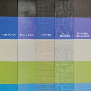 May include: A close-up of a colour palette showcasing different textures and hues. The samples include non-woven, peel & stick, and textured materials in shades of blue, white, green, and purple. Each sample is labelled with its name.