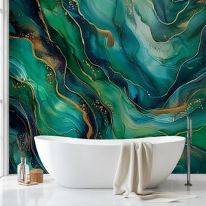 May include: A modern bathroom with a white, oval-shaped bathtub. The wall behind the tub features a vibrant, abstract design in shades of green, teal, and gold. A beige towel hangs on the tub's edge, and a silver faucet is visible.
