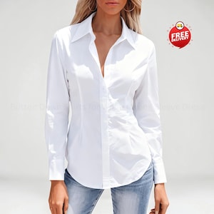 May include: A crisp white long-sleeve button-down shirt featuring a classic collar, a central button placket, and tailored seams that provide a fitted silhouette. The shirt is paired with blue denim jeans, creating a clean and structured appearance.