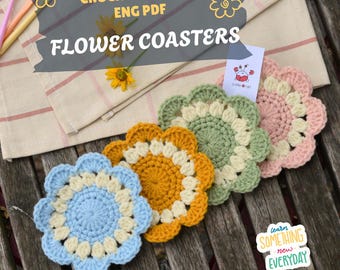 May include: A collection of handmade crochet flower coasters in various colors, including blue, yellow, green, and pink. The coasters are arranged on a wooden surface with a striped cloth and text that reads "CROCHET PATTERN ENG PDF FLOWER COASTERS."