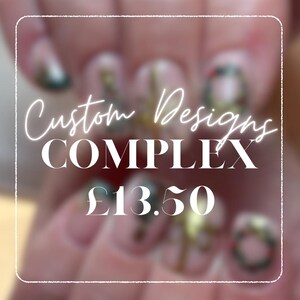 May include: Close-up of nails with custom designs. The nails have a complex design with gold and green accents. The text "Custom Designs COMPLEX" is displayed in white. The image also shows the price of £13.50.