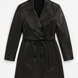 May include: A black, double-breasted trench coat with a notched collar and a matching belt. The coat features a sleek, minimalist design with a tailored fit. The coat is made of a smooth, leather-like material.