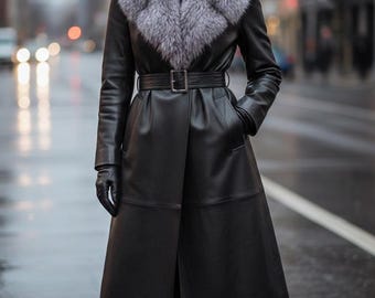 May include: A long black leather coat with a gray fur collar and a matching belt. The coat features a classic design with a tailored fit, long sleeves, and a knee-length hem. The model is wearing black gloves and boots.