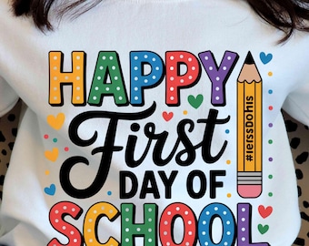 May include: White sweatshirt with a colorful "Happy First Day of School" graphic. The design includes a pencil, hearts, and polka dots. The text "#lerssDoHis" is printed on the pencil.