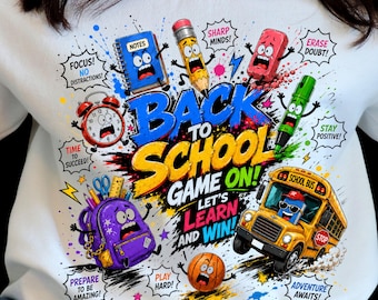 May include: A white sweatshirt featuring a colorful graphic with the text BACK TO SCHOOL GAME ON! LET'S LEARN AND WIN! surrounded by cartoon school supplies like a pencil, eraser, alarm clock, backpack, and a yellow school bus with faces.