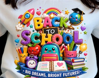 May include: A light blue sweatshirt featuring a colorful graphic with the text BACK TO SCHOOL and BIG DREAMS, BRIGHT FUTURES. The design includes a rocket, globe, rainbow, apple, backpack, alarm clock, books, and a notebook with the text DREAM LEARN FOCUS SUCCEED.