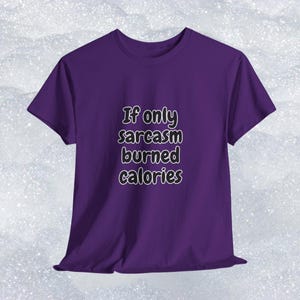 Someone modeling a comfortable short-sleeve shirt with a relatable and funny fitness quote. The bold text reads "If only sarcasm burned calories". This funny gym t-shirt for fitness lovers is a brilliant option for a humorous workout shirt or everyday casual wear.