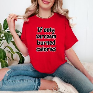 Detailed view of the chest area on a casual top showcasing the bold lettering "If only sarcasm burned calories". This if only sarcasm burned calories tee is a perfect gift for gym rats and sarcastic friends who love relatable gym humor apparel for their daily wear.