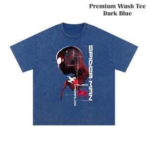 May include: Dark blue premium wash tee featuring a graphic of Spider-Man's profile in red and black, with the words "SPIDER-MAN" and "MILES MORALES" in white. The shirt has short sleeves and a crew neck.