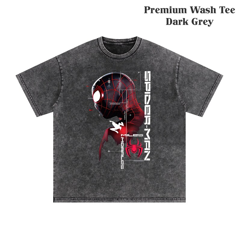 May include: Dark grey premium wash tee featuring a graphic of Spider-Man's head in red and black with the text "SPIDER-MAN" and "MILES MORALES". The shirt has a crew neck and short sleeves.