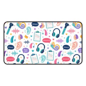 May include: A white rectangular mouse mat with a black border, featuring a repeating pattern of hearing-related illustrations. The design includes hearing aids, ears, headphones, charts, and speech bubbles with the words "connect", "communicate", and "hear you".