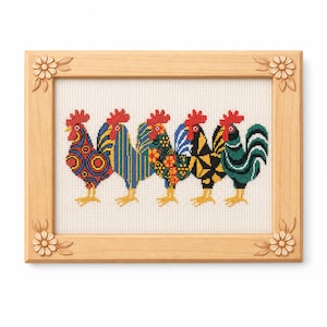May include: A framed cross-stitch featuring five colorful roosters. Each rooster has a unique pattern in red, blue, yellow, and green. The frame is made of light-colored wood with carved floral accents in each corner. The roosters are standing on a white background.