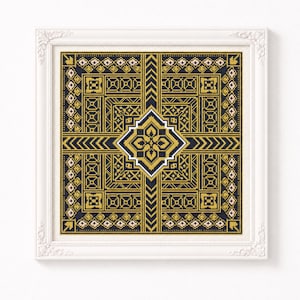 Puede incluir: Un bordado de punto de cruz cuadrado con un patrón geométrico simétrico en negro, dorado y crema. El diseño se centra en un motivo de diamante rodeado de bordes intrincados, galones y pequeños acentos florales, todo dentro de un marco blanco.