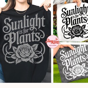 May include: Black t-shirt and tote bags with the text "Sunlight is for Plants" in a decorative font. A gray rose graphic is centered below the text. The tote bags are white and gray.