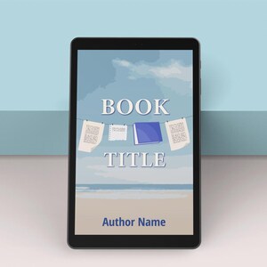 May include: A black tablet shows a book cover design. The cover has the words "BOOK TITLE" in white, set against a beach scene. The author's name is at the bottom. Papers and a book are hanging on a washing line.
