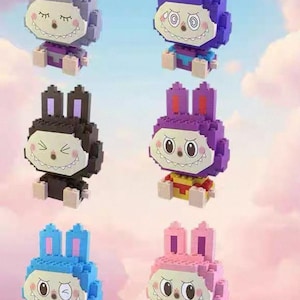 May include: Six small, block-built figures shaped like rabbits with distinct facial expressions and color schemes. Each figure features large, pointed ears, a wide mouth with visible teeth, and small limbs. The figures are colored gray, purple, black, violet, blue, and pink.