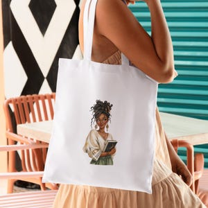 May include: White tote bag featuring an illustration of a woman with glasses, holding a book. The woman has dark hair and is wearing a white blouse and green skirt. The bag has white straps.