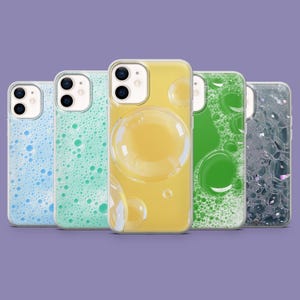 May include: A collection of five phone cases with bubble-themed designs. The cases feature a variety of colors, including blue, green, and yellow, with clear cases showcasing bubble patterns. The cases are designed to fit a smartphone.