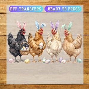 May include: DTF transfers with the text "READY TO PRESS". The image features four chickens wearing Easter bunny ears. One chicken holds a basket of eggs, while others hold decorated eggs. Colorful Easter eggs are scattered around the chickens.