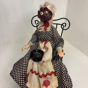 horror doll old lady exploding face