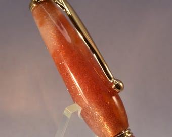 Sparkling Orange with a Hint of Gold Glitter and a Crystal on Top