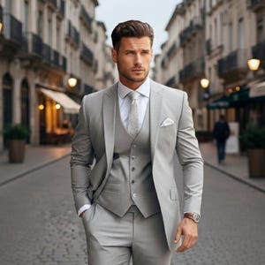 May include: A trio of ceramic mugs with a speckled, matte finish in cream, light grey, and dark grey. Each mug features a simple, minimalist design, ideal for tea or coffee.