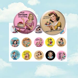 May include: A collection of round, retro-style pinback buttons with vintage illustrations of women. The buttons feature phrases like "Fresh Sarcasm Served Daily" and "I Baked You Some Shut the Fucupcakes." The color palette includes pink, yellow, and blue.