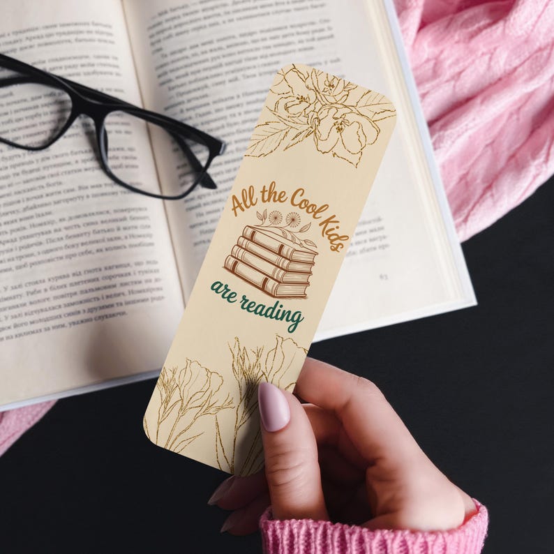 Set of four vintage floral bookmarks featuring botanical line art and reading quotes in neutral tones, displayed on a soft background with daisies and books.