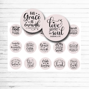 May include: A sheet of light pink stickers with various inspirational quotes in black script. The stickers are round and feature phrases like "His Grace is Enough" and "Love Anchors the Soul." The overall theme is religious and motivational.