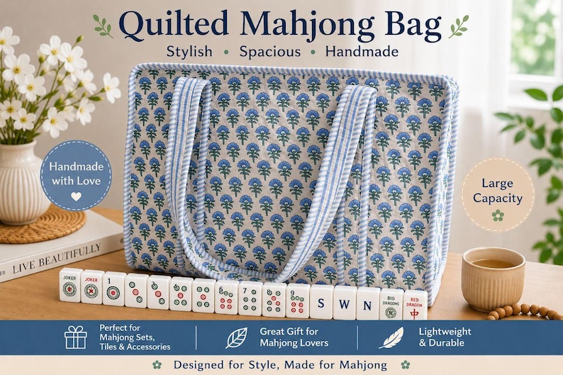 Blue floral quilted mahjong tote bag with striped handles and spacious padded design, displayed with American mahjong tiles and cozy tabletop decor, featuring a stylish handmade large-capacity organizer for mahjong sets and accessories.