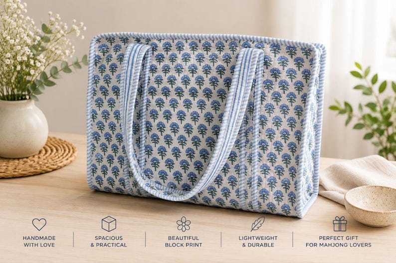 May include: A rectangular quilted tote bag featuring a blue and white floral block print pattern. The bag has two striped fabric handles and matching striped trim along the edges. Below the bag, text reads: HANDMADE WITH LOVE, SPACIOUS & PRACTICAL, BEAUTIFUL BLOCK PRINT, LIGHTWEIGHT & DURABLE, PERFECT GIFT FOR MAHJONG LOVERS.