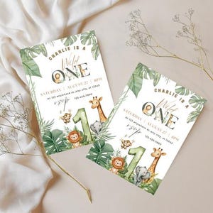 May include: Two invitations with a jungle theme. The invitations read "Charlie is a Wild One" with illustrations of a lion, giraffe, elephant, and monkey. The invitations are decorated with green leaves and the number "1".
