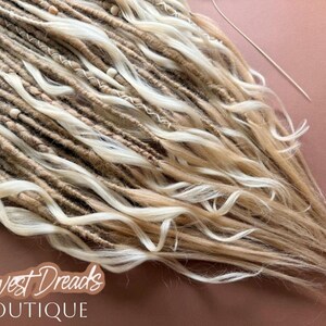 a close-up view of a collection of blonde dreads, with the text "Harvest Dreads Boutique" written in a stylized font.