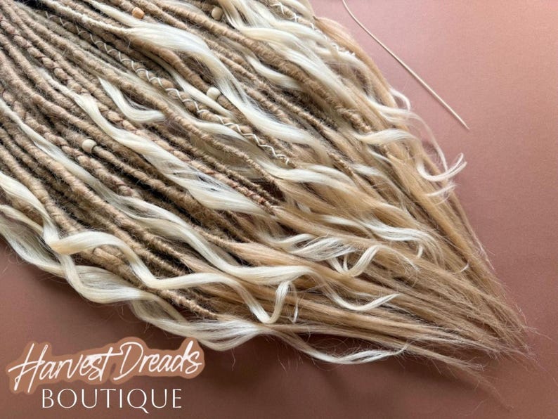 a close-up view of a collection of blonde dreads, with the text "Harvest Dreads Boutique" written in a stylized font.