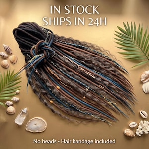 May include: A set of synthetic dreadlocks in shades of brown, black, and blue, featuring wavy textures and decorative wraps. The text IN STOCK SHIPS IN 24H and No beads • Hair bandage included is visible. The dreadlocks are arranged in a bundle.