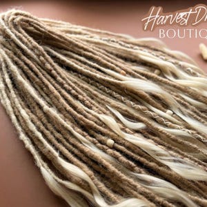 a close-up view of a bundle of braided hair, with the text "Harvest Dreads Boutique" written above it.