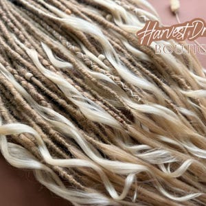 a close-up view of a collection of braided hair strands, with a focus on the intricate details and textures of the braids.