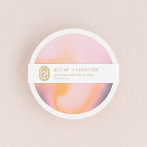 May include: A set of four pink and orange coasters with a swirl pattern. The coasters are made in the USA and are good for hundreds of uses.