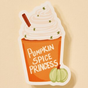 May include: Orange and white sticker with a pumpkin spice latte illustration. The latte has whipped cream and a cinnamon stick. The text on the sticker says "Pumpkin Spice Princess" and there is a small green pumpkin on the bottom right.