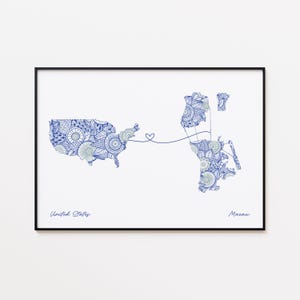 May include: A framed art print featuring a blue and white patterned map of the United States and Macau, connected by a heart-shaped line. The words "United States" and "Macau" are written below the maps.