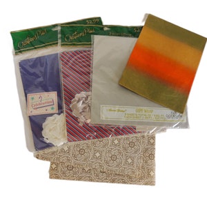 May include: Assortment of gift wrap sheets in various designs. Includes a blue sheet with a "Celebration" sticker, a red and white striped sheet with a bow, and a sheet with an orange, yellow, and green gradient. Also includes a sheet with a beige floral pattern.