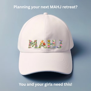 May include: A white baseball cap with the word "MAHJ" spelled out in colorful floral letters. The text "Planning your next MAHJ retreat?" and "You and your girls need this!" are also visible.