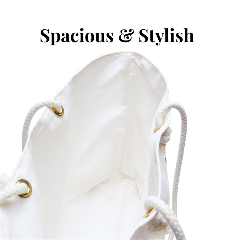 May include: White tote bag with rope handles and gold-colored grommets. The bag's interior is visible, and the text "Spacious & Stylish" is at the top. The bag appears to be made of a soft, white fabric.