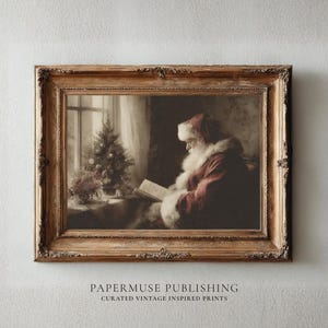 May include: A framed vintage print depicts Santa Claus reading by a window with a small Christmas tree. Santa is wearing a red suit with white fur trim and a matching hat. The frame is ornate with a gold finish. The text "PAPERMUSE PUBLISHING" is at the bottom.