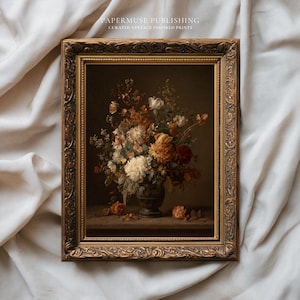 May include: A framed vintage-inspired print featuring a still life of flowers in a dark vase. The flowers are in shades of white, orange, and red. The frame is ornate with a gold finish. The text "PAPERMUSE PUBLISHING CURATED VINTAGE INSPIRED PRINTS" is at the top.